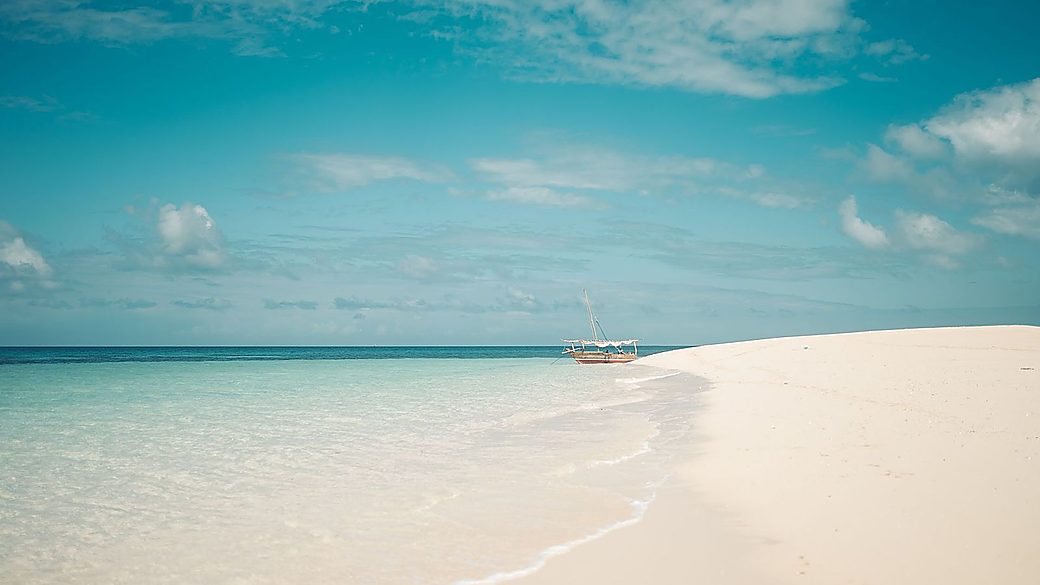 A dhow on a turquoise sandbank on Safari Blue